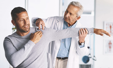 Doctor assisting patient with arm movement