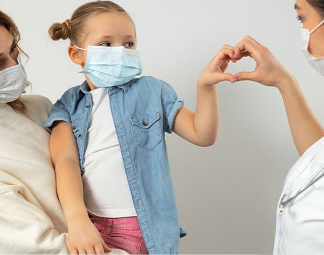 child holding heart hands with a nurse